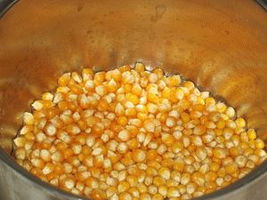 высыпать кукурузу в горячее масло для жарки попкорна